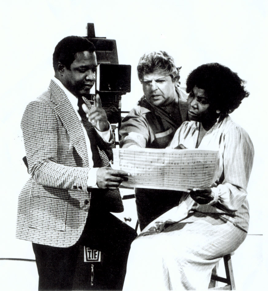 Prior to shooting a scene from documentary “Harriet Tubman- Moses of Her People”, Carlos, musical director, discusses musical score with Robert Pinson, director and Dr. Alice Johnson, author.