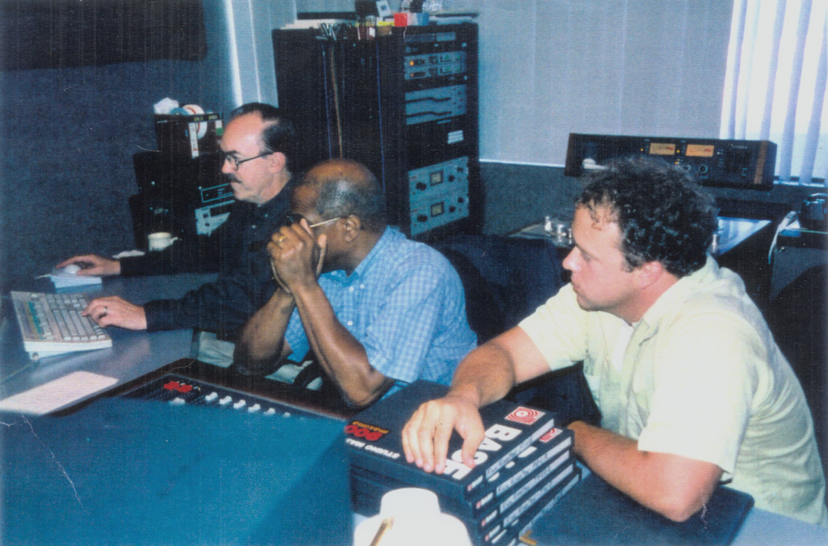 In the recording studio of Capitol Records, Los Angeles, senior technician (left) discusses mixing session with Carlos Malcolm (center) and Robert Way, President of Athanasia Productions.